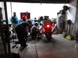 people working on a motorcycle